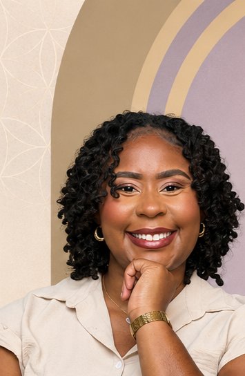Shonta J. Caruthers, seated and smiling